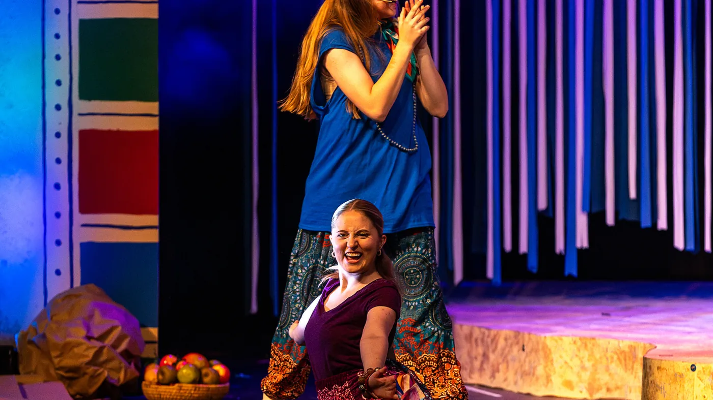 Ensemble scene under stage light